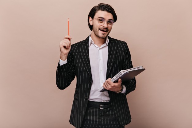 elegant-young-teacher-with-brunette-hair-in-stylish-light-shirt-black-striped-suit-glasses-holding-writings-pen-and-giving-lecture_197531-24666.jpg